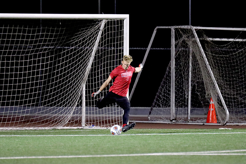 Photo of Biola soccer player about to kick the ball