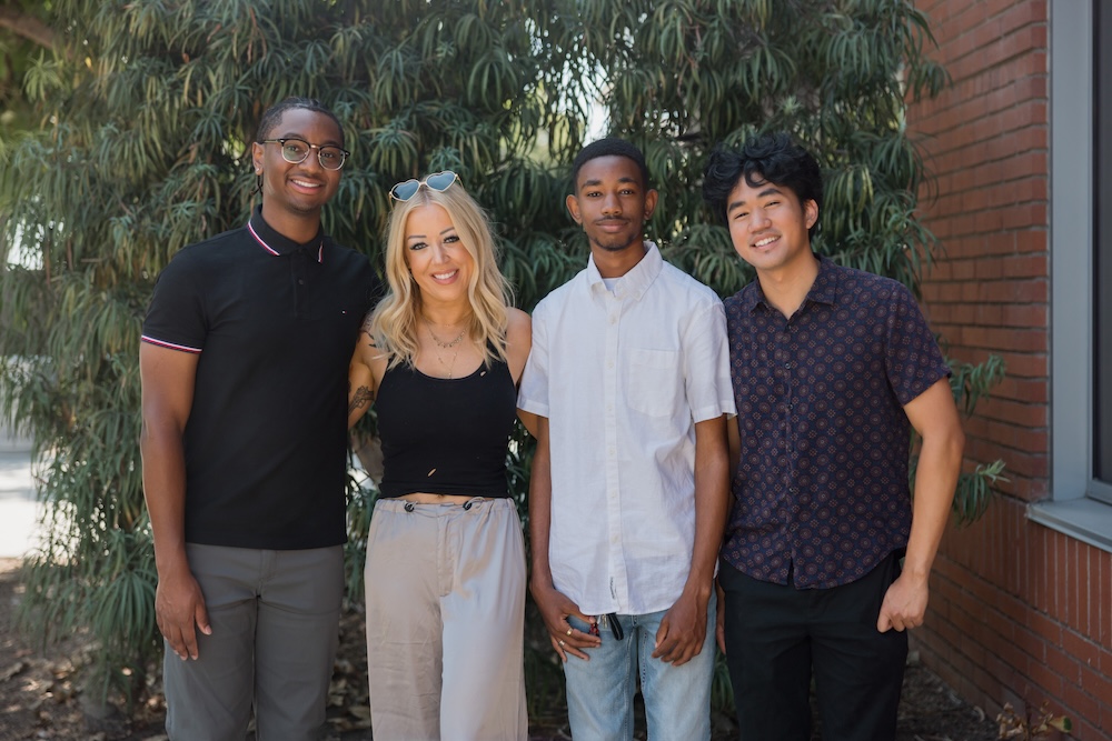 Lynsi Snyder-Ellingson with three scholarship recipients