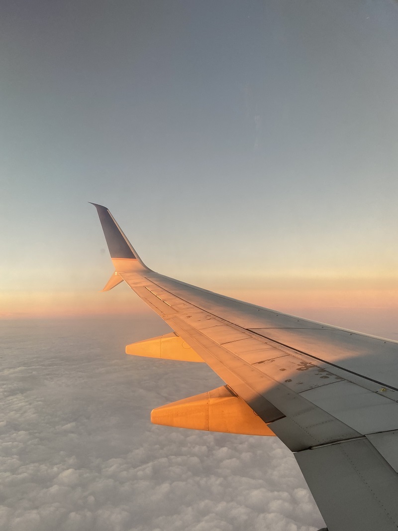 Looking outside a plane window at sunset