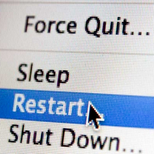 A mouse arrow highlights the Restart option on a computer screen.