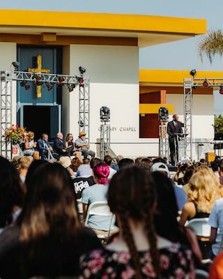 Image shows André Stephens speaking on stage at the Fall 2021 Convocation Chapel