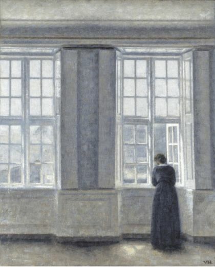 Painting by Vilhelm Hammershøi of women looking at window in a muted blue grand room.