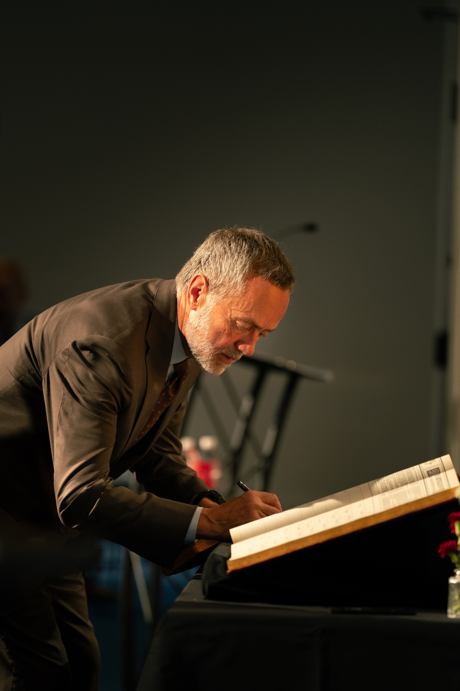 image shows Barry Corey signing his name