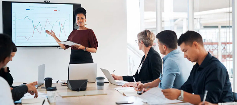 woman leading a presentation in front of colleagues