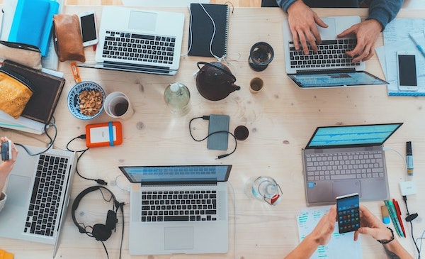 Several computers, hard drives, cell phones and busy students