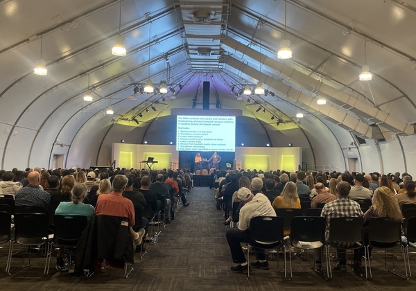 Chris and Alisa speaking at large marriage conference