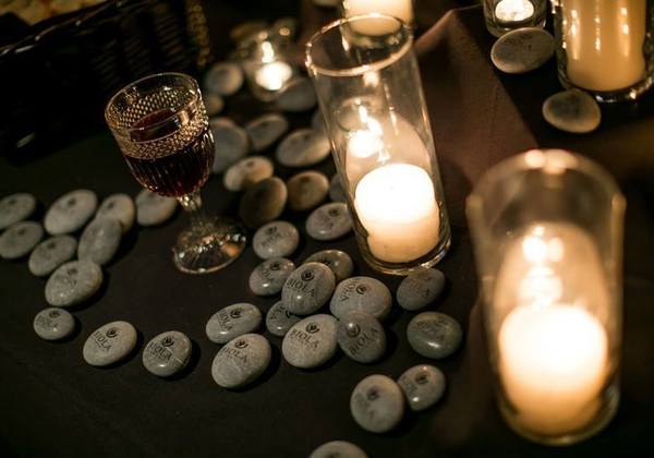 lit candles and biola logo rocks