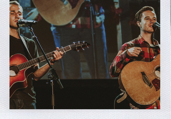 Students playing guitars at previous talent show event