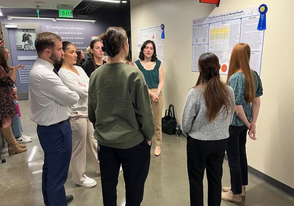 Students hearing from others about their research presentations.