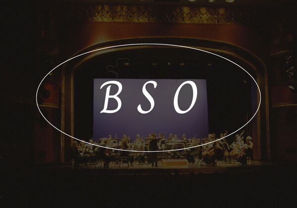 The Letters "BSO" on a darkened photo of an orchestra