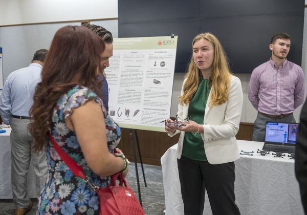 Student presenting poster