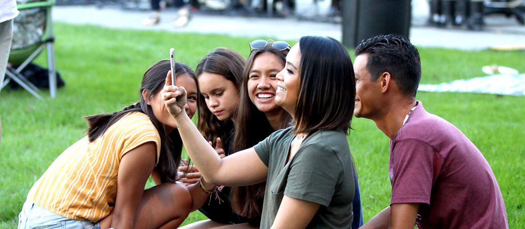 female student taking selfie with family