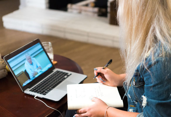 woman watching a lecture on a laptop