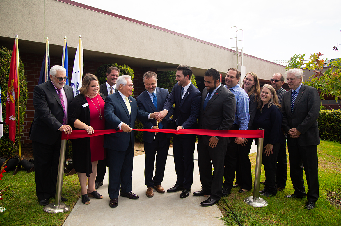 President Corey and group cutting ribbon.