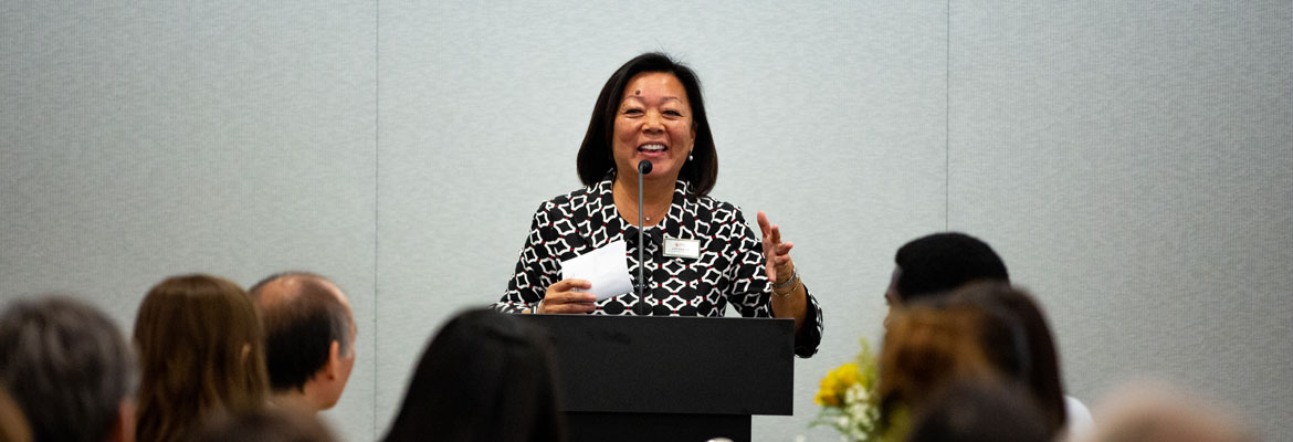 Lily Tsau speaking at the MLK Luncheon