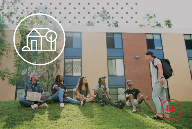 A group of students talking and laughing on the grass in front of residence hall