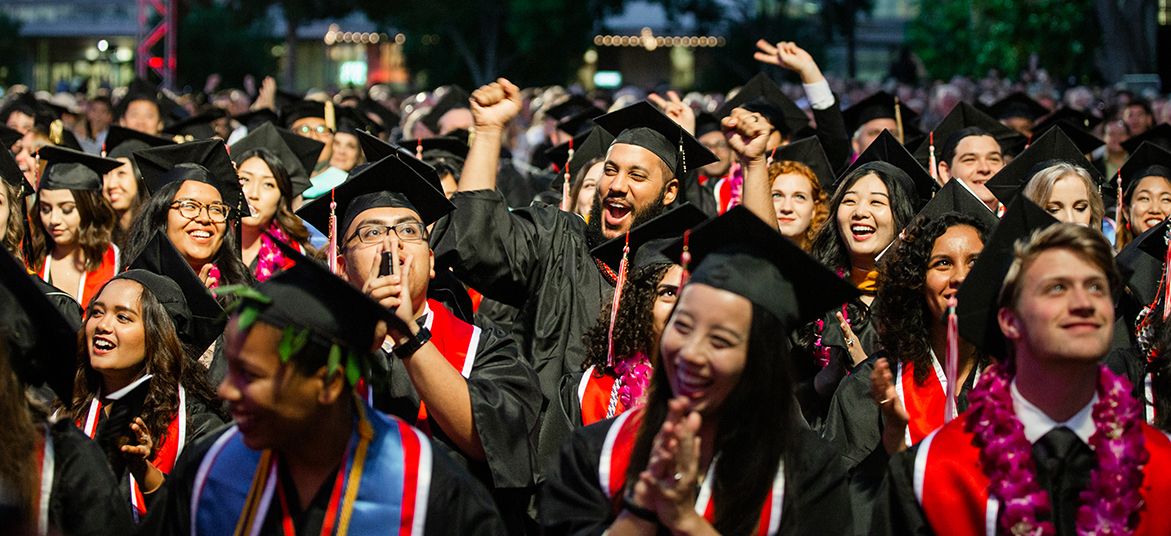 Students in graduation caps and gowns.