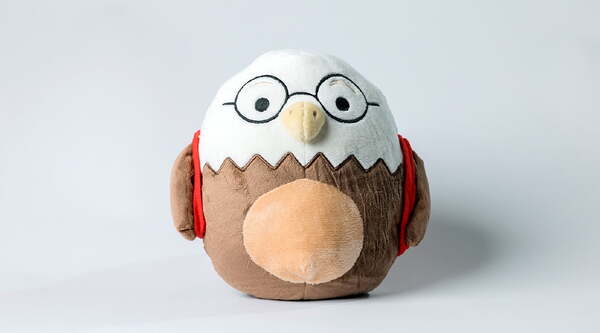 a plush eagle wearing glasses
