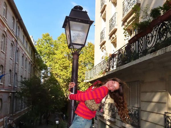 Biola student posing with lamp post