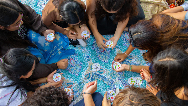 students huddled playing games