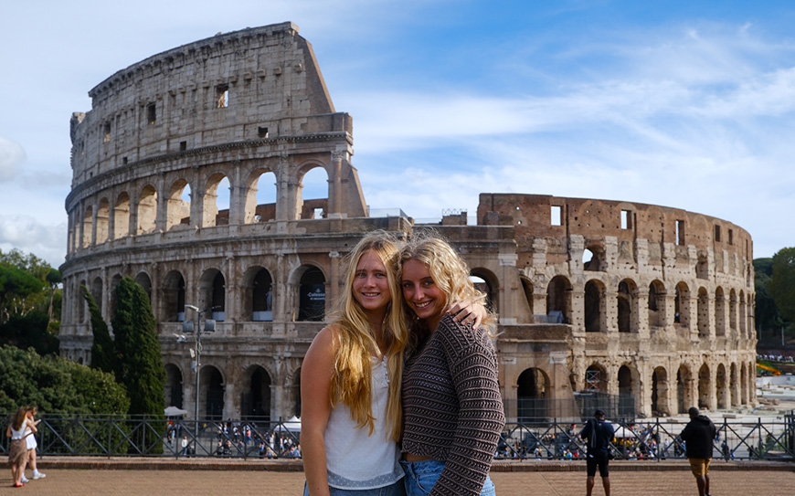 two students in front of colosseum