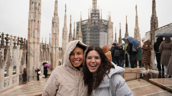 Two girls smiling on a rainy day