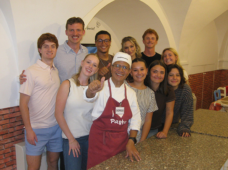 group of students with pasta chef