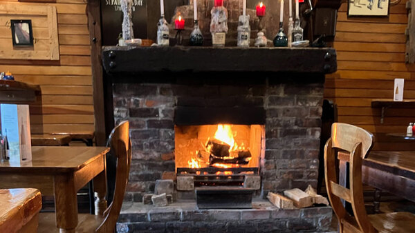 a rustic fireplace in a cafe