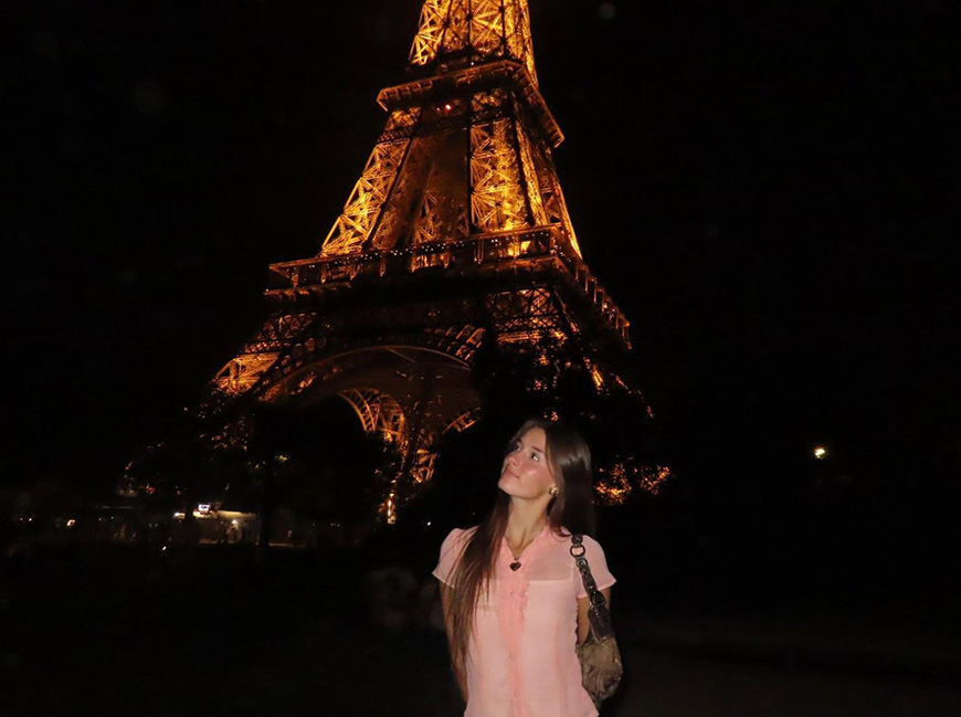female student in front of Eiffel Tower
