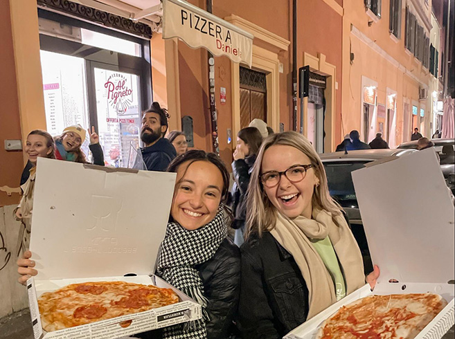 two Biola students in front of pizzeria in Rome