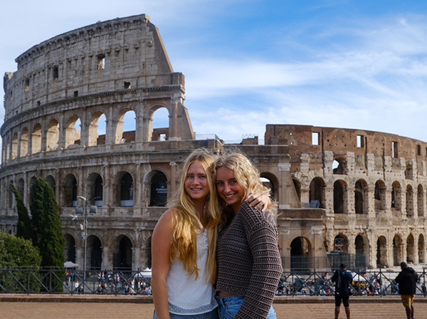 two students in front of colosseum