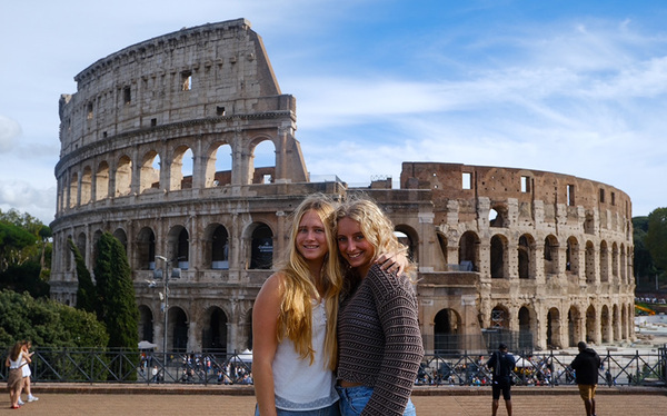 two students in front of colosseum