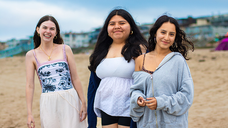 three students at the beach