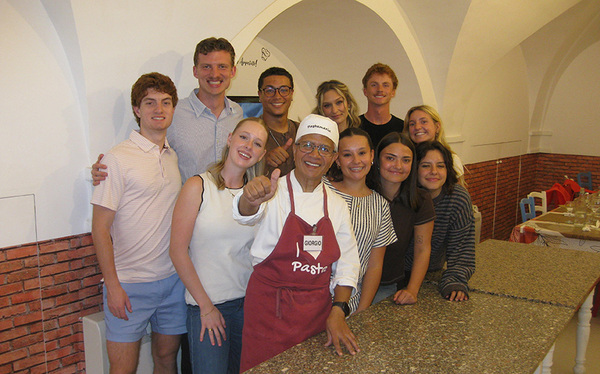 group of students with pasta chef