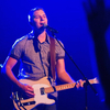 young man playing a guitar and singing