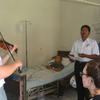 young woman playing a violin in a hospital