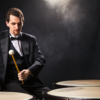 Male student playing timpani drums