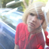 reflection of young woman in front of a car